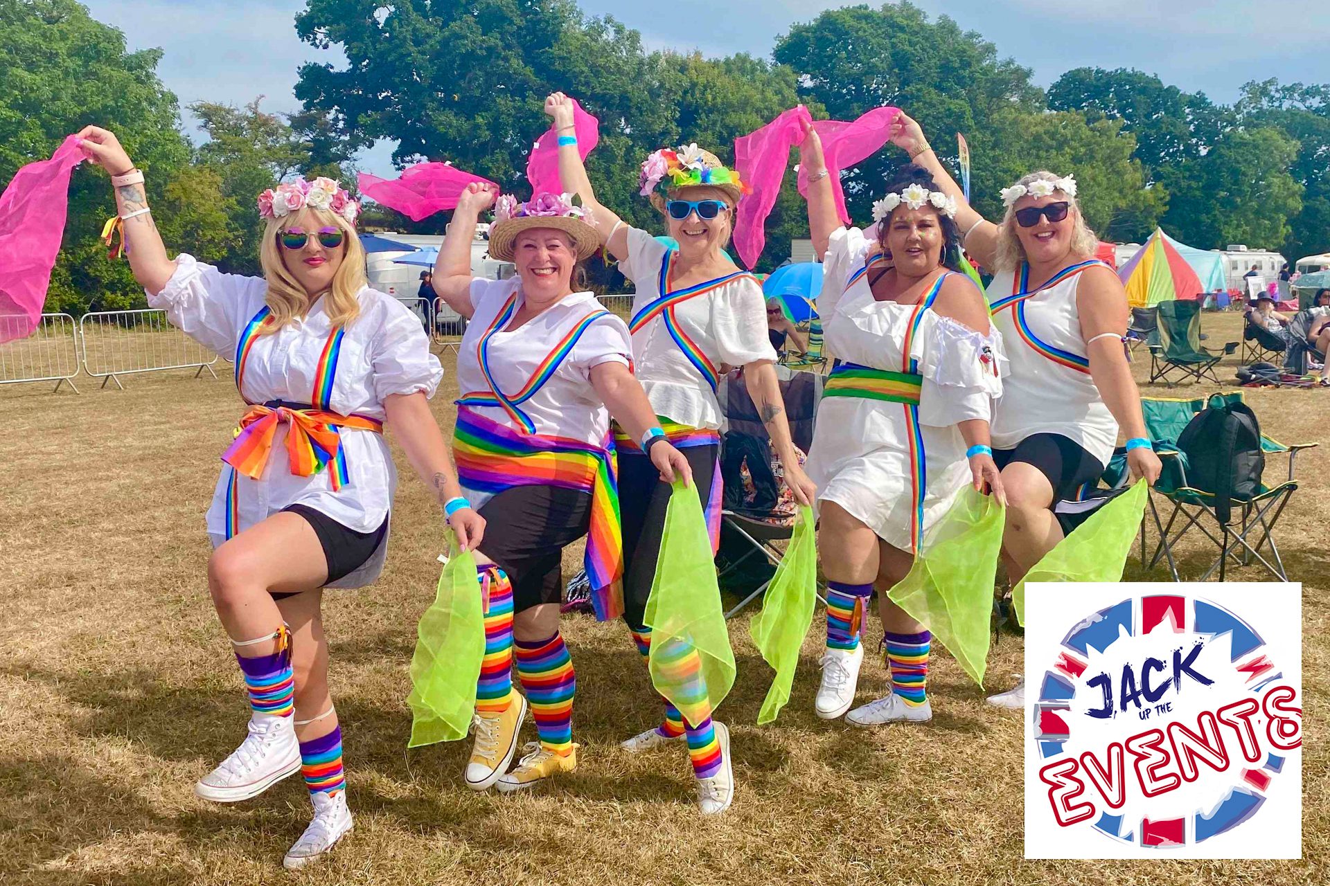 Group of girls dressed as Morris dancers holding coloured hankies